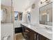 Bathroom featuring a double vanity with a marble countertop and a glass enclosed shower at 2576 Krameria St, Denver, CO 80207
