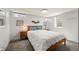 Cozy bedroom with natural light, wood frame bed, and side tables, creating a relaxing atmosphere at 2576 Krameria St, Denver, CO 80207