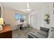 Cozy bedroom with a ceiling fan, light gray sofa, large window, and closet at 2576 Krameria St, Denver, CO 80207