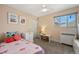 Bright bedroom with a comfortable bed, plush carpet, and plenty of natural light at 2576 Krameria St, Denver, CO 80207