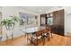 Stylish dining area with hardwood floors, a wooden table, and dark wood built ins, adjacent to the kitchen at 2576 Krameria St, Denver, CO 80207