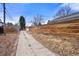Long driveway leading to the garage, lined by a wooden fence at 2576 Krameria St, Denver, CO 80207