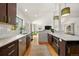Beautiful modern kitchen with stainless appliances, dark wood cabinets, and a large island open to the living room at 2576 Krameria St, Denver, CO 80207