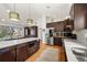 Spacious kitchen with stainless steel appliances, dark wood cabinets, and white countertops at 2576 Krameria St, Denver, CO 80207
