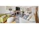 Cozy living room offers a comfortable seating area with a brick fireplace and an arched window for natural light at 2576 Krameria St, Denver, CO 80207