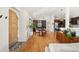 Spacious living area with hardwood floors seamlessly connects to dining and kitchen areas, creating an open-concept layout at 2576 Krameria St, Denver, CO 80207