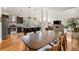 Open concept living and dining area features a modern kitchen with stainless appliances and spacious seating at 2576 Krameria St, Denver, CO 80207