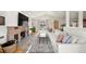 Bright living space features a brick fireplace, a sectional sofa, and an arched doorway, perfect for relaxing at 2576 Krameria St, Denver, CO 80207