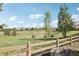Picturesque backyard view with a wooden fence, lush greenery, and neighboring houses, offering a serene and community-oriented setting at 25548 E Fair Dr, Aurora, CO 80016