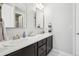 Bright bathroom boasts double sinks with quartz countertops, modern fixtures and plenty of storage space at 25548 E Fair Dr, Aurora, CO 80016