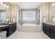 Luxury bathroom features a soaking tub, dual vanities, and decorative niches for a spa-like experience at 25548 E Fair Dr, Aurora, CO 80016