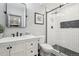 Modern bathroom features sleek white tiles, a glass-enclosed shower, and contemporary fixtures, creating a spa-like retreat at 25548 E Fair Dr, Aurora, CO 80016