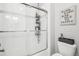 Bathroom featuring a walk-in shower with glass doors, white subway tile and toilet at 25548 E Fair Dr, Aurora, CO 80016