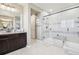 Modern bathroom featuring glass enclosed shower, dark wood vanity, and bright tile flooring at 25548 E Fair Dr, Aurora, CO 80016