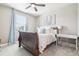 Cozy bedroom with a wooden sleigh bed, neutral colors, and a ceiling fan creates a relaxing space at 25548 E Fair Dr, Aurora, CO 80016