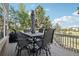 Outdoor deck with a dining table set and grill, perfect for alfresco dining and enjoying the natural scenery at 25548 E Fair Dr, Aurora, CO 80016