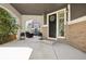 Welcoming front porch with comfortable seating, decorative wreath, and stylish brick accents at 25548 E Fair Dr, Aurora, CO 80016