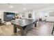 Spacious game room offering a ping pong table, ample seating, fireplace and open layout, ideal for entertainment at 25548 E Fair Dr, Aurora, CO 80016