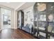 Stylish hallway with dark wood floors, elegant decor, and display cabinets adds character and charm to the home at 25548 E Fair Dr, Aurora, CO 80016
