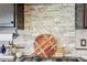 Elegant kitchen backsplash with stone accents and modern accessories, over gas range at 25548 E Fair Dr, Aurora, CO 80016