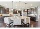 Spacious kitchen featuring a large central island, pendant lighting, stainless appliances and wood floors at 25548 E Fair Dr, Aurora, CO 80016