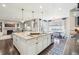 Open kitchen with large island featuring bar seating, and stainless steel dishwasher. Overlooks living area at 25548 E Fair Dr, Aurora, CO 80016