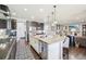 Open kitchen with large island featuring bar seating, and stainless steel dishwasher. Overlooks living area at 25548 E Fair Dr, Aurora, CO 80016