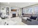 Stylish living room featuring a cozy fireplace, built-in shelving, and comfortable seating arrangement at 25548 E Fair Dr, Aurora, CO 80016