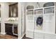 Mudroom with custom storage lockers, wine fridge, dark cabinets and access to outdoor space at 25548 E Fair Dr, Aurora, CO 80016