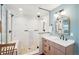Modern bathroom featuring a glass-enclosed shower with marble tiling, modern fixtures, and a vanity with a sink at 1455 Flowers Ct, Erie, CO 80516