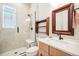 Bathroom featuring a walk-in shower, modern vanity, and stylish fixtures at 1455 Flowers Ct, Erie, CO 80516