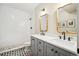 Bathroom featuring a dual vanity with modern fixtures and a walk-in shower at 1455 Flowers Ct, Erie, CO 80516