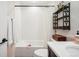 Bright bathroom with tub, shower, decorative shelving, and a neutral color palette creating a relaxing atmosphere at 1455 Flowers Ct, Erie, CO 80516