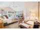 Bright bedroom with vaulted ceilings featuring a dedicated study area and outdoor views through expansive windows at 1455 Flowers Ct, Erie, CO 80516