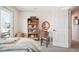 Well-lit bedroom with balcony access, a bookshelf, and a vanity at 1455 Flowers Ct, Erie, CO 80516