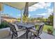 Relax on the covered patio with a table and chairs, perfect for outdoor dining and entertaining at 1455 Flowers Ct, Erie, CO 80516
