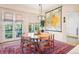 Dining area with unique light fixture, map decor, and outdoor access through french doors at 1455 Flowers Ct, Erie, CO 80516