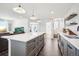 Open-concept kitchen featuring a large island and views of the living area and entrance at 1455 Flowers Ct, Erie, CO 80516