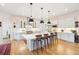 Contemporary kitchen featuring stainless steel appliances, modern island and hardwood floors at 1455 Flowers Ct, Erie, CO 80516