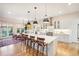 Open concept kitchen leading to dining area, with stainless steel appliances and large island at 1455 Flowers Ct, Erie, CO 80516