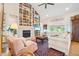 Inviting living room featuring a cozy fireplace and a floor-to-ceiling bookshelf at 1455 Flowers Ct, Erie, CO 80516