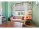 Bright sitting room with large windows, a comfortable sofa, and stylish decor at 1455 Flowers Ct, Erie, CO 80516