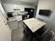 Kitchen featuring granite countertops, stainless steel appliances, modern cabinetry and a dining area at 9440 E Girard Ave # 1, Denver, CO 80231