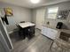 Eat-in kitchen featuring granite countertops, gray wood-look flooring, and seating for four at 9440 E Girard Ave # 1, Denver, CO 80231