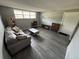 Inviting living room with gray walls, wood-look floors, a comfy sofa, and a large window at 9440 E Girard Ave # 1, Denver, CO 80231