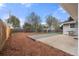 Private backyard with wood deck, mulched garden beds, and fenced perimeter at 712 S Longmont Ave, Lafayette, CO 80026
