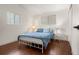 Comfortable bedroom featuring a bed, hardwood floors, two windows, and two nightstands at 712 S Longmont Ave, Lafayette, CO 80026