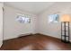 Bright bedroom with hardwood floors and natural light from two large windows at 712 S Longmont Ave, Lafayette, CO 80026