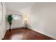 Cozy bedroom features wood floors, a bright window, and a decorative plant at 712 S Longmont Ave, Lafayette, CO 80026
