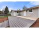 Backyard with a wooden deck, concrete patio, mulched garden beds and gray home exterior at 712 S Longmont Ave, Lafayette, CO 80026